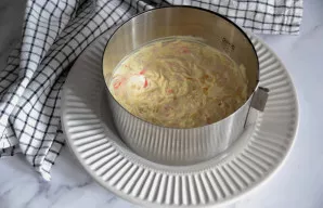 Patepkite krabų sluoksnį plonu majonezo sluoksniu. Kiekvieną kitą sluoksnį taip pat patepkite majonezu.