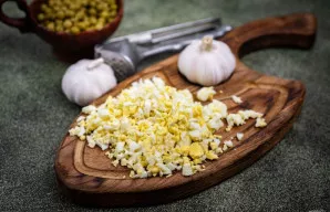 Virti kiaušiniai nulupami ir smulkiai supjaustomi.