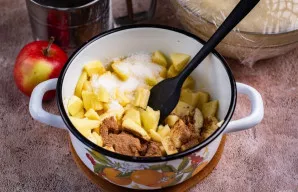 Sudėkite obuolius į puodą, įdėkite sviestą, cukrų ir cinamoną. Kaitinkite ant silpnos ugnies, maišydami, kol cukrus ištirps. Įdaras paruo...