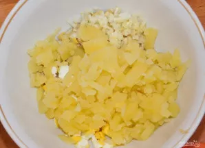 Įdėkite kubeliais supjaustytas bulves ir smulkintą svogūną.