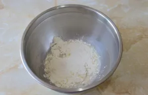 Po truputį suberkite persijotus miltus ir minkykite tešlą. Miltų kiekį reguliuokite pagal tešlos konsistenciją.