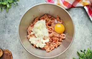 Svogūną susmulkinkite bet kuriuo patogiu būdu - aš tiesiog sutarkuoju stambia tarka. Sudėkite svogūną į faršą su kiaušiniu.