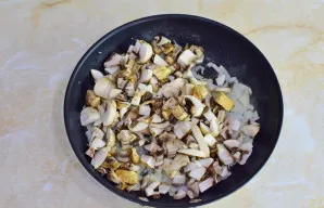 Sudėkite grybus į keptuvę prie svogūnų. Išmaišykite. Kepkite kartu dar 12-15 minučių.