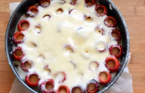 Sudėkite antrą spanguolių sluoksnį ir užpilkite likusia tešla. Pabarstykite cukrumi palei kraštą ir šiek tiek ant viršaus.