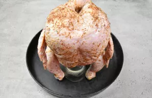 Uždėkite vištą ant skardinės. Ji turi laikytis tvirtai ir stabiliai. Konstrukciją perkelkite ant skardos ar kepimo formos, kad nutekėtų r...