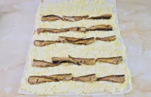 Ant įdaro išdėliokite šprotus.